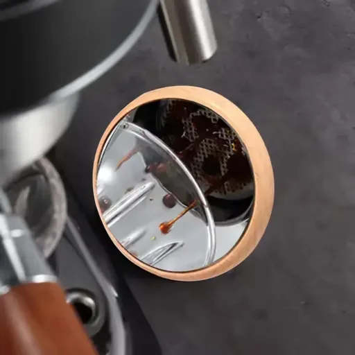 Espresso extraction seen in a mounted mirror placed below a naked portafilter