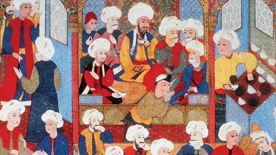 A historical Ottoman miniature artwork depicting figures in traditional attire gathered in an early coffeehouse, drinking coffee from small cups, illustrating the cultural origins of Feketeleves.